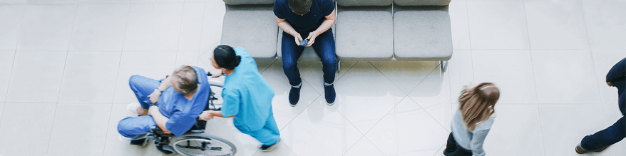 Nurse Pushing man in Wheel Chair